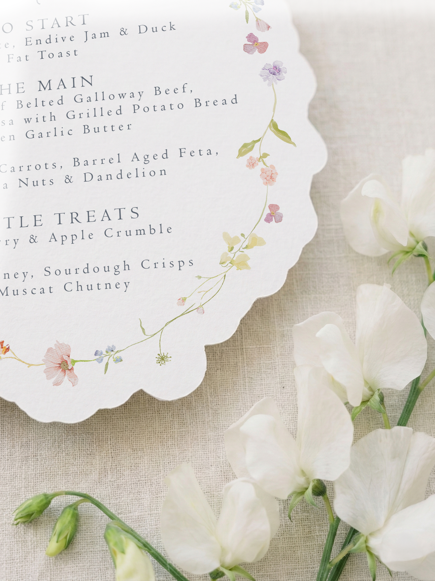 Menu with floral design on a textured surface with white flowers